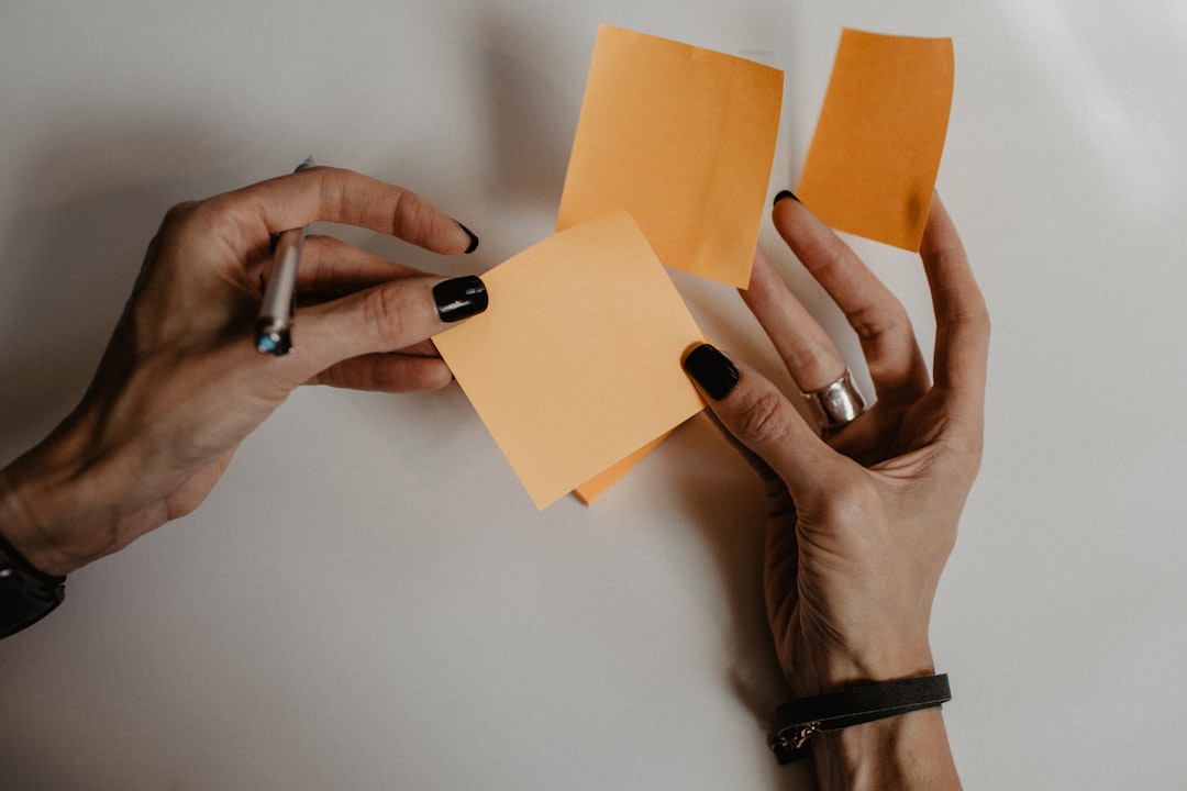 hands holding sticky notes